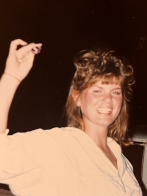 Carol teaching the gang how to snap a bottle cap. circa 1987